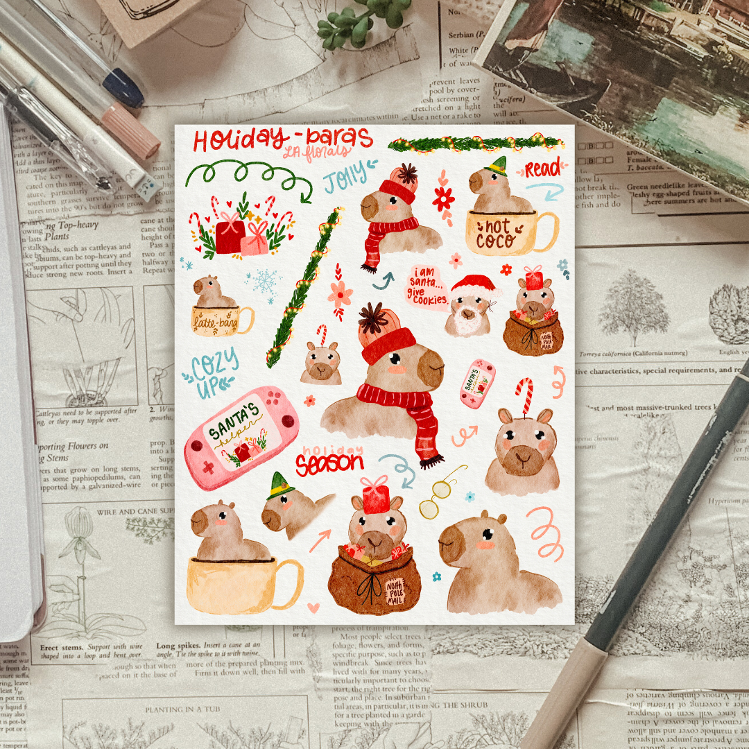 A sheet of stickers with hand-drawn artwork featuring capybaras in various festive poses, with Christmas-themed elements like Santa hats, gifts, and decorative text.