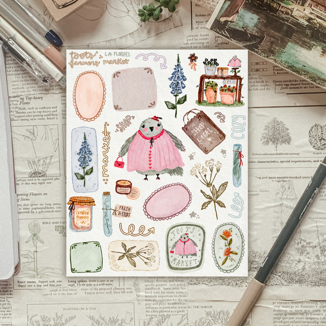 Sheet of decorative stickers with illustrations on a textured surface with stationery items.