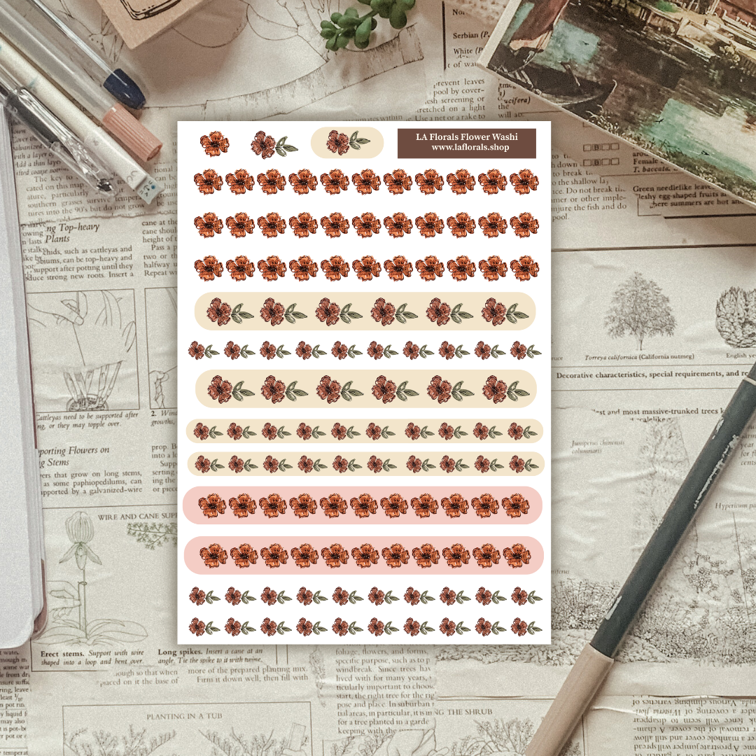 Sheet of floral stickers on a textured paper background with stationery items.