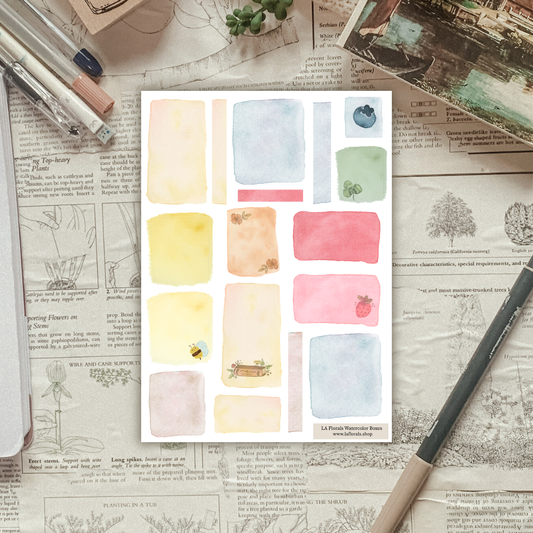 Textured background with a sticker sheet of watercolor swatches laying on top. 